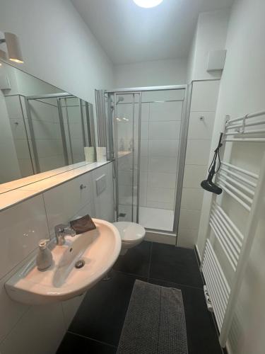 a white bathroom with a sink and a toilet at Wohlfühl-Oase in Herne