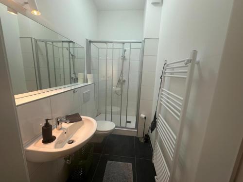 a bathroom with a toilet and a sink and a shower at Wohlfühl-Oase in Herne