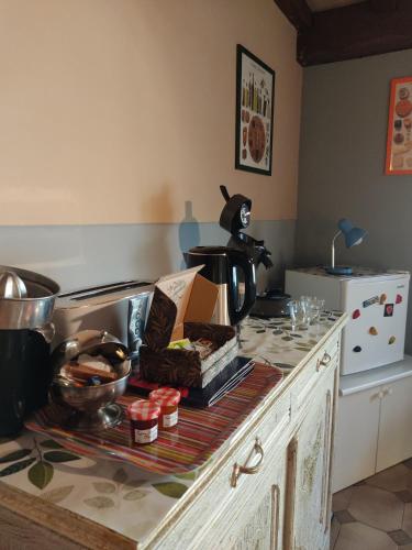a kitchen with a counter top with a table with a tea kettle at Chambre d'hôtes Zen à Mazamet, avec garage vélos motos in Mazamet