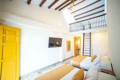 a room with a couch and a tv and a door at Casa Serafin Hotel in Salento