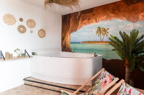 a bathtub in a room with a painting on the wall at La Caliente love room glamour balnéo en duo in Gujan-Mestras