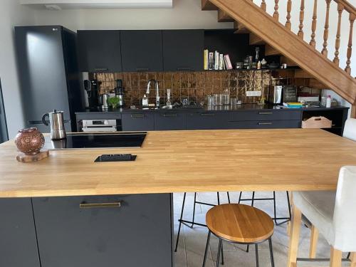 une cuisine avec un comptoir en bois dans une pièce dans l'établissement Jolie maison de village proche de la mer, à Clohars-Fouesnant