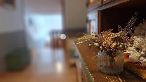 a vase filled with flowers sitting on a table at Hotel zum Kreuz in Sankt Peter