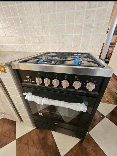 a stove top oven sitting in a kitchen at Island Escape Villa in Curepipe