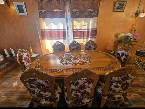 a dining room with a wooden table and chairs at Island Escape Villa in Curepipe