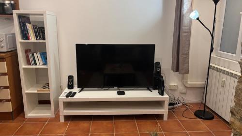 a flat screen tv sitting on a white entertainment center at Studio Carré d 'Or - 5 minutes de la mer in Nice