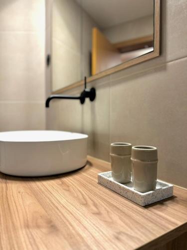 a bathroom with a tub and a sink on a counter at Apartamento do Ferreiro in Ponte da Barca