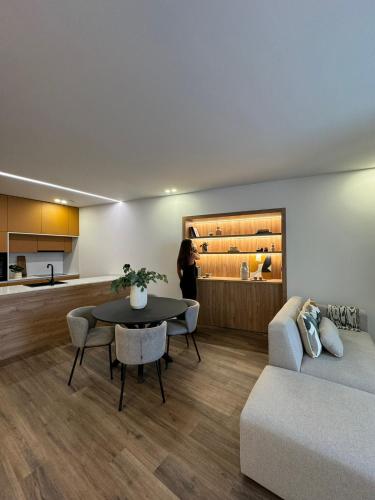 a living room with a table and a couch at Apartamento do Ferreiro in Ponte da Barca