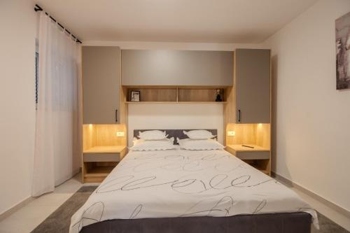 a bedroom with a large bed with the word love written on it at Villa Alesa Steva in Tučepi