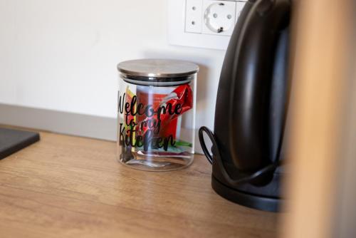 a glass jar sitting on a table next to a coffee pot at Villa Alesa Steva in Tučepi