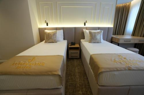 a hotel room with two beds in a room at Avdissons Hotel in Prizren