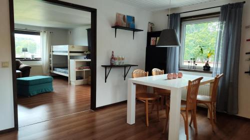 a kitchen and dining room with a white table and chairs at Lägenhet i Skärhamn nära hav och natur! in Skärhamn