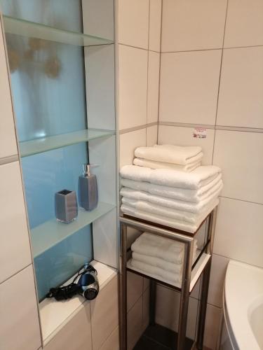a pile of towels on a shelf in a bathroom at Stella Mare in Tučepi