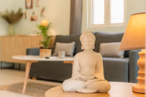a statue sitting on a table next to a lamp at Lemonanthos Villa in Káto Kalésia
