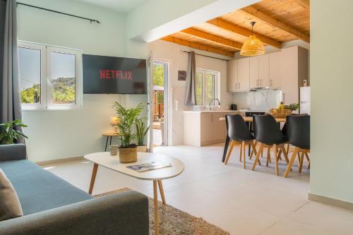 a living room with a couch and a table at Lemonanthos Villa in Káto Kalésia