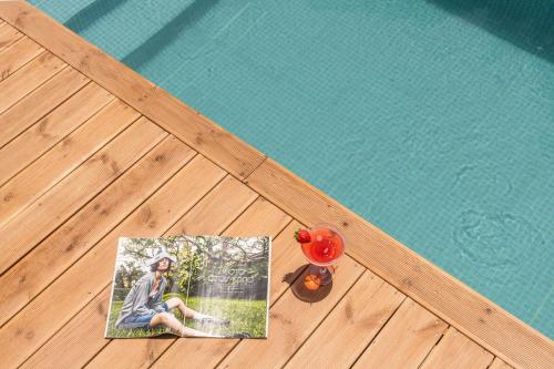 a picture of a woman next to a swimming pool at Lemonanthos Villa in Káto Kalésia