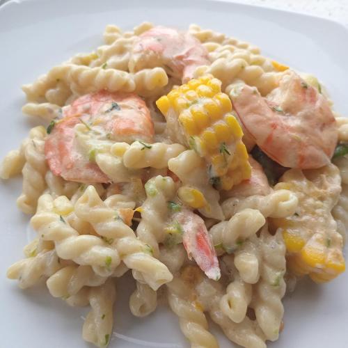 a plate of pasta with shrimp and corn at Nature in portland Eco Villas in Port Antonio