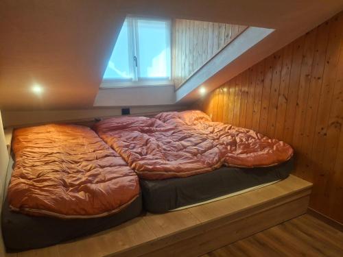 a large bed in a room with a window at Inner Holiday Dolomites 5 in Dimaro