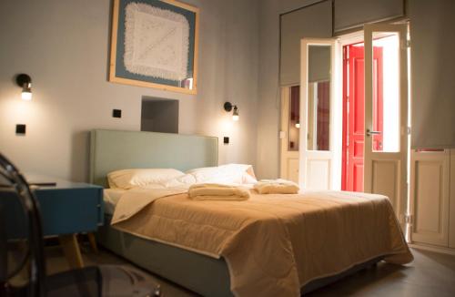 a bedroom with a bed with two towels on it at Porta Di Marina in Chios
