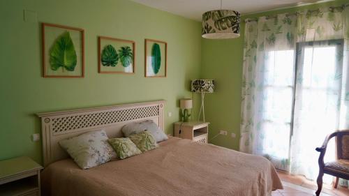 a bedroom with a bed and a window at Chalet Adosado for Rent in Sotogrande in San Roque