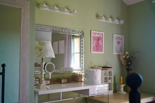 a room with a mirror and a table with a lamp at Chalet Adosado for Rent in Sotogrande in San Roque