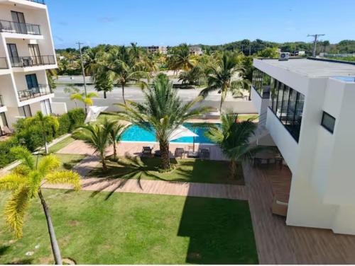 an aerial view of a resort with a pool and palm trees at Central Park Down Town F2 in Punta Cana