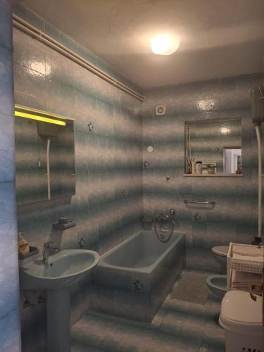 a bathroom with a tub and a sink and a toilet at VILLA Apartments Mate Cebalo in Lumbarda