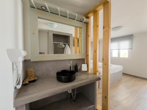a bathroom with a sink and a mirror at Aegean Paradiso Vacation Club - "Adults Only" in Azolimnos