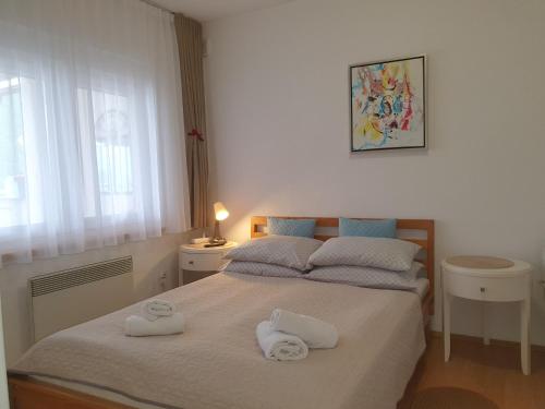 a bedroom with a bed with two towels on it at Apartman Relax Čelebići in Konjic