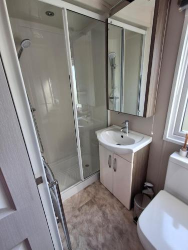 a bathroom with a shower and a sink at Holiday Home on Billing Aquadrome in Great Billing