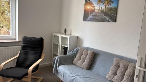 a living room with a couch and a chair at Tannenhaus 3 bedrooms in Kassel