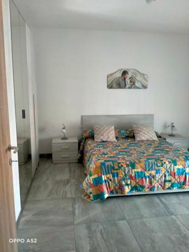a bedroom with a bed with a picture on the wall at Perla Marina in Montesilvano