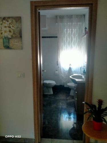 a bathroom with a toilet and a sink and a window at Perla Marina in Montesilvano