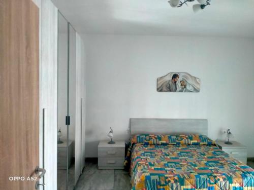 a bedroom with a bed with a picture on the wall at Perla Marina in Montesilvano