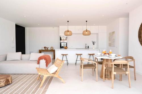 a living room and kitchen with a table and chairs at Villa Lima by Aura Collection in La Oliva