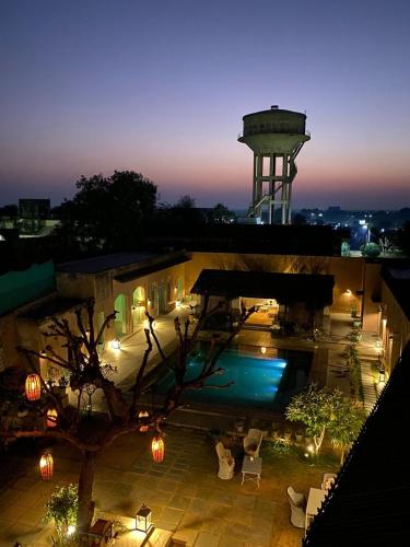 a view of a building with a water tower at night at Mandawa Kothi in Mandāwa