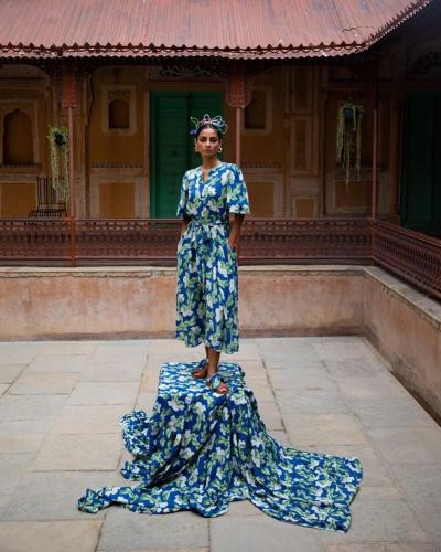 a woman in a dress standing in front of a building at Mandawa Kothi in Mandāwa