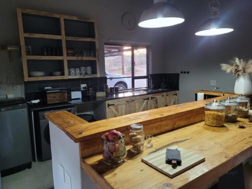 a kitchen with a wooden counter top in a kitchen at Switsongo B&B in Hoedspruit