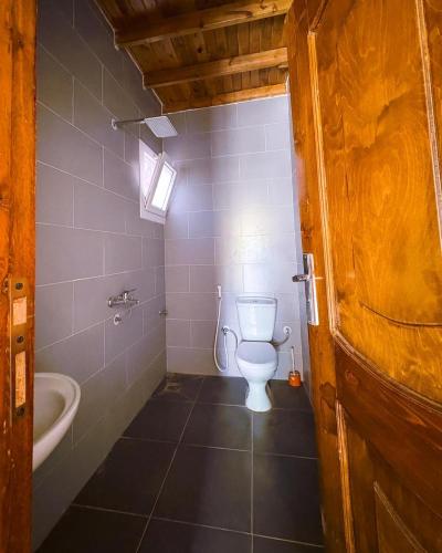a bathroom with a toilet and a sink and a tub at Baghdady's Home in Dahab