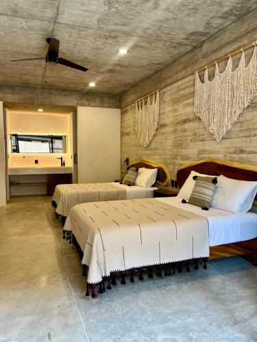 a bedroom with two beds in a room at Jiloo Beautiful Oasis in Punta Zicatela 3 in Brisas de Zicatela