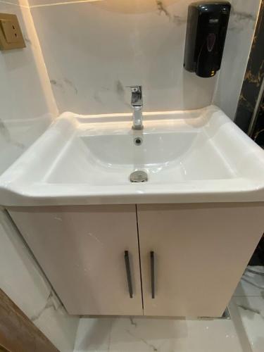 a white sink in a bathroom with a counter at Golden Season Hotel in Cairo