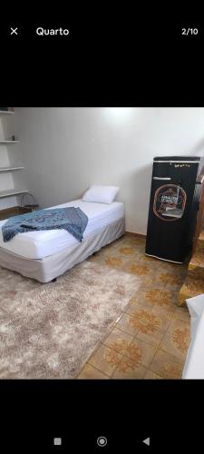 a bed sitting in a room with avertisement at Botucatu in Botucatu