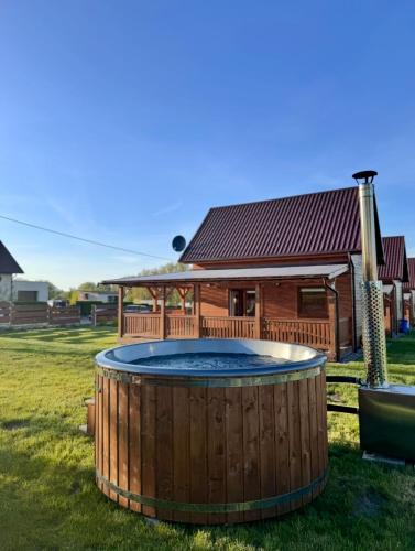 a hot tub in front of a house at Chabrowa Oaza in Sasino
