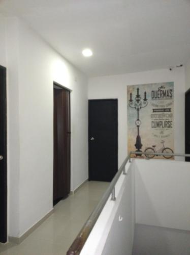 a hallway with stairs and a black door at Casa Lina in Montería