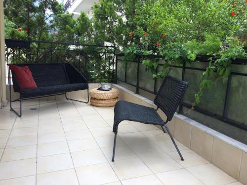 two chairs and a table on a patio at Moris Luxury Apartments 1 in Thessaloniki