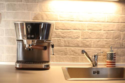 a coffee maker sitting on a counter next to a sink at Moris Luxury Apartments 1 in Thessaloniki