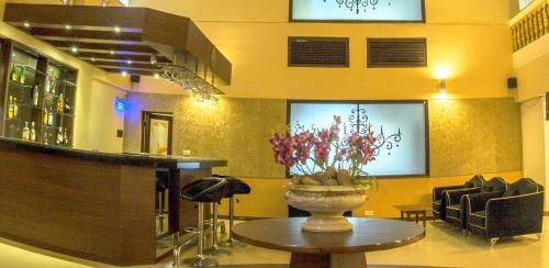 a lobby with a vase of flowers on a table at The Queeny in Vasco Da Gama