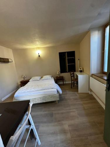 une chambre avec un lit et un bureau dans l'établissement Studio 2 Aux volets bleus, à Aulus-les-Bains