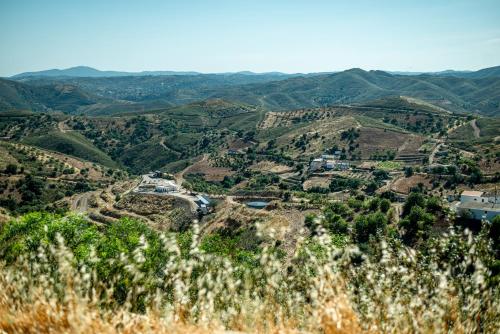 a view of a valley in the hills at Portugals Infinity Eco Suite Resort in Tavira