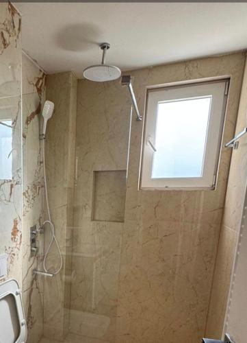 a bathroom with a shower and a window at Crater H in Kukrike